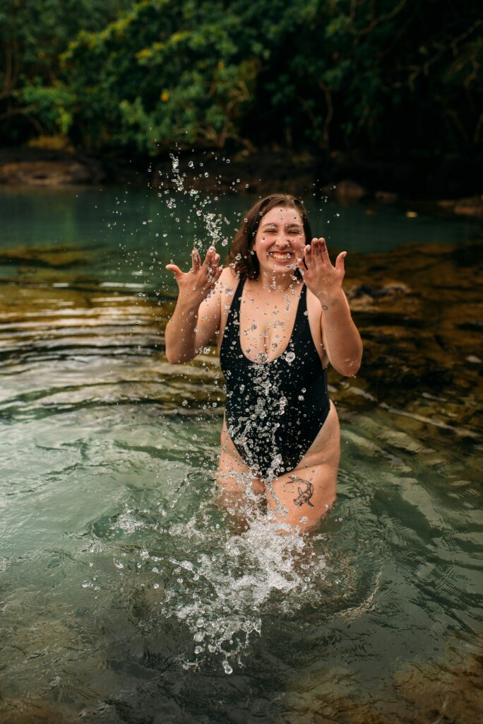 Women in swimming costume splashing water